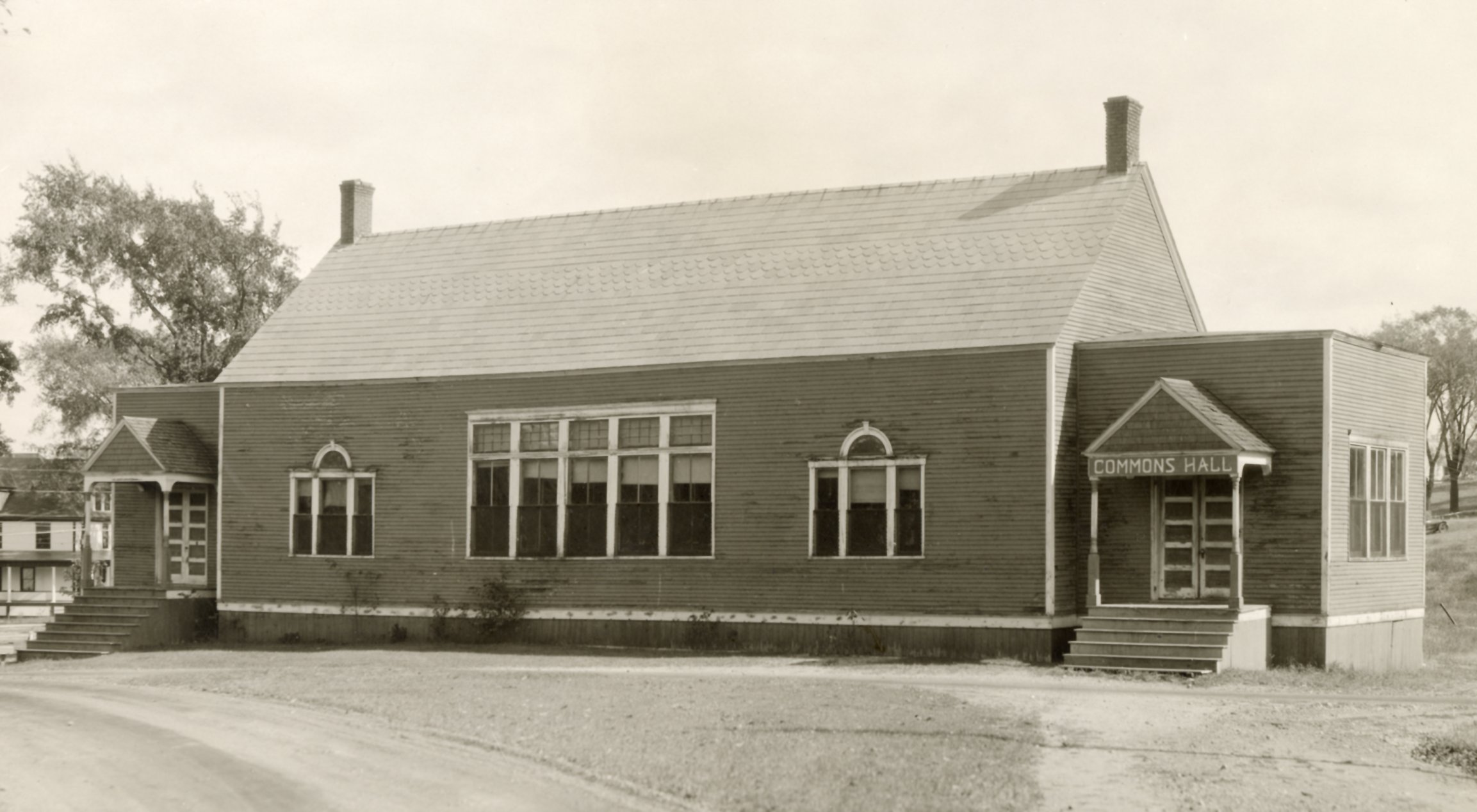 1929 photograph of Commons Hall, a frame building with slate roof and decorative windows..