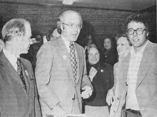 Three men  and two women photographed at a political forum.